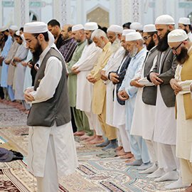Congregation standing in rows for prayer